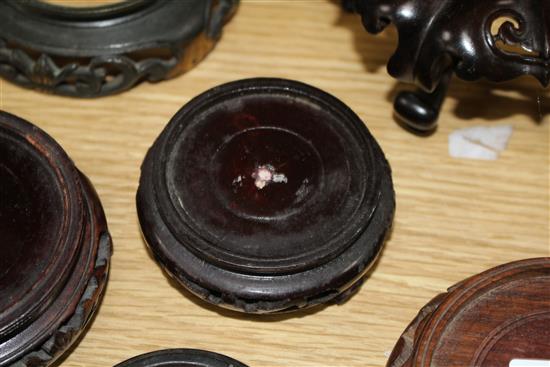 Thirteen assorted mainly Chinese hardwood vase stands, largest diameter 17cm, height 12cm